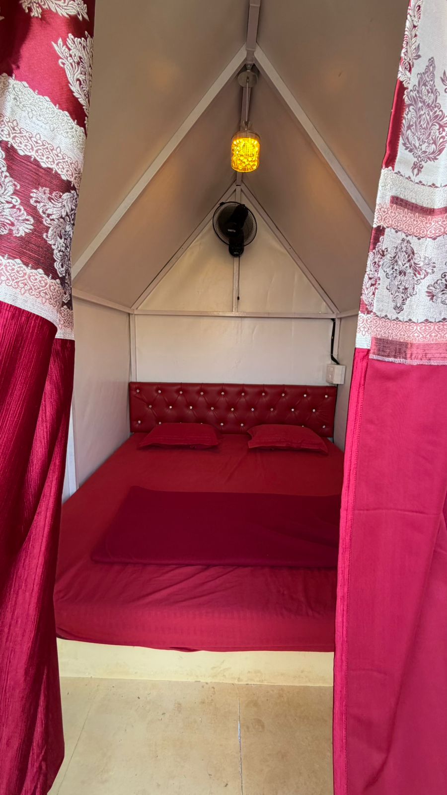 Front view of the triangular tent with bedding inside
