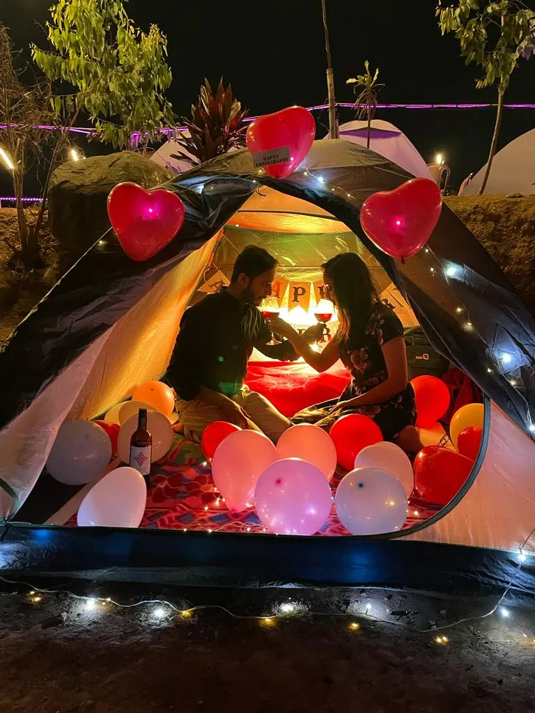Couple inside a decorated tent with balloons