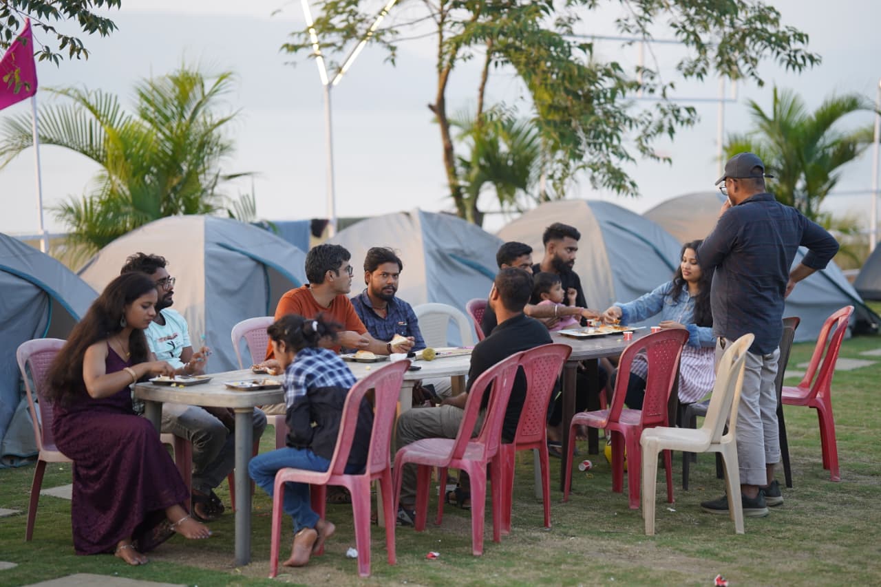 Tents with outdoor dining tables at Pawna Machi