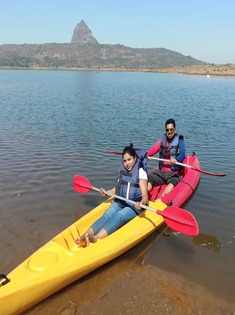 Guests kayaking on Pawna Lake near the campsite